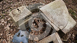 Old computer in a junkyard in the forest, slow motion