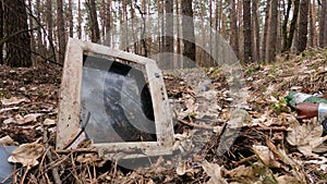 Old computer in a junkyard in the forest, slow motion