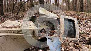 Old computer in a junkyard in the forest, slow motion