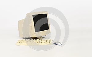 Old computer with keyboard and mouse on white background