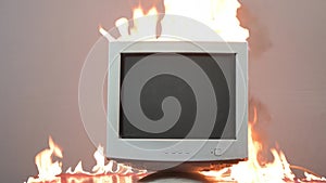 An old computer monitor is on fire. Fire hazardous situation in the apartment, causes of fire, short circuit.