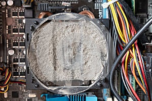 Old computer system unit cooler with dust inside. Dust on the computer pc processor cooler with computer case fragment