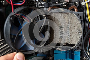 Old computer system unit cooler with dust inside. Dust on the computer pc processor cooler with computer case fragment