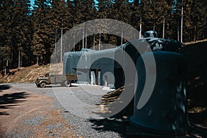 An old concrete bunker with a truck in forest. Orlicke hory. Czechia.