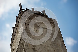 Old concrete column with metal studs