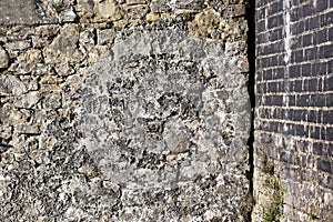 Old concrete covered red brick wall background