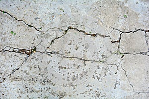 Old concrete ground floor panel, large cracks. Texture of damaged cement block