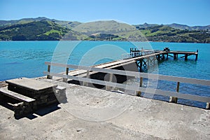Old concrete pier with rails and table