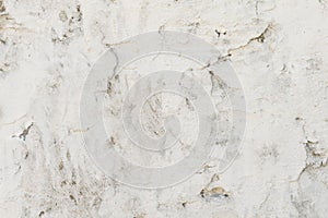 old concrete wall is painted with white paint, background