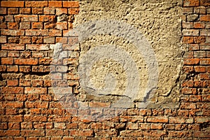 Old concreted boarded up window on a derelict red brick wall photo