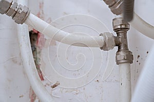 Old connection fitting tee on plastic pipes