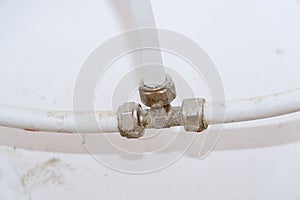 Old connection fitting tee on plastic pipes