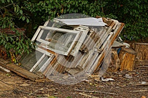 Old construction debris from window frames and broken glass on the street