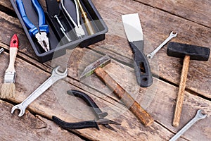 Old construction tools on rustic wooden boards.