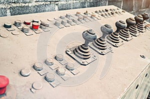 Old control unit is covered with dust. Joysticks to control equipment in the factory