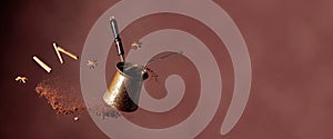 Old copper coffee maker and a spoon with ground coffee in motion