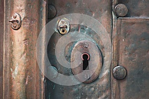 Old copper door with key hole and rivets