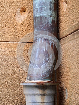 Old Copper Drain Pipe on Sandstone Building