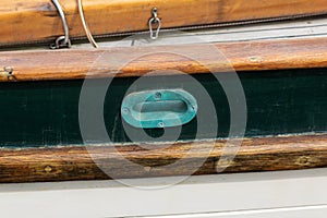 Old copper hawsehole on a vintage sailing ship, old wooden vessel, heavy verdigris patina photo