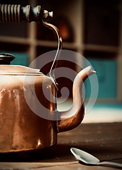 Old copper kettle on wood