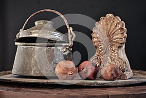 Old copper pot. cooker, bowl and pomegranate fruit