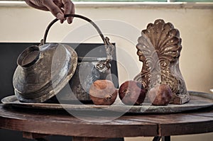 Old copper pot. cooker, bowl and pomegranate fruit