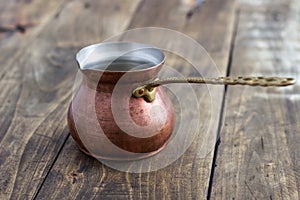 Old copper pot on table