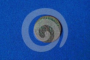 Old copper Russian coin on a blue background