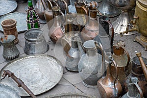 Old copperware placed on pavement