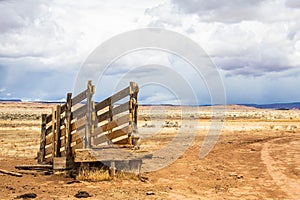 An old corral, abandoned in the desert of Arizona under a blue sky with bright white