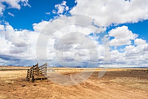 An old corral, abandoned in the desert of Arizona under a blue sky with bright white