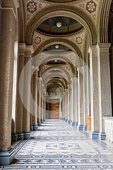 An old corridor with a beautiful floor and painted ceilings