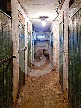Old corridor in a old basement. Green doors