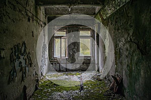 Old. corrupted room covered in moss in the building located in the Chernobyl ghost town