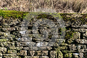 Old Cotswold dry stone wall with moss