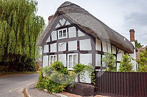 thatched Old cottages, timber frame houses in contryside photo