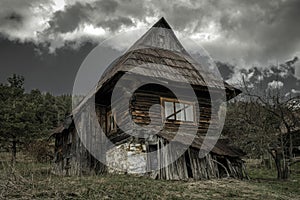 Old cottage and dark clouds