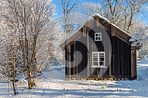 Old cottage in winter with snow