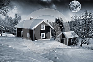 Old cottages and full moon in winter landscape