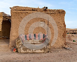 Old couch in front of a building inside the desert in Marrakech, Morocco