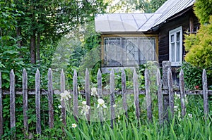 Old country house with porch and rustic wood fence