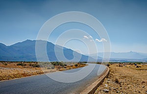 Old country road among mountain and wilderness area