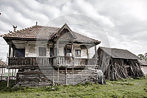 Old countryside house and an old barn in a Romanian village