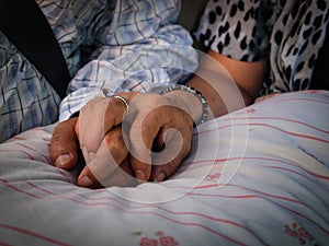 Old couple holding each other hands photo