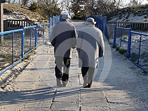 Old couple after beach walk