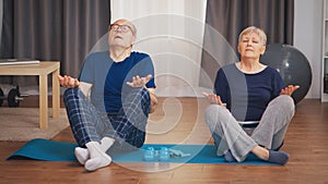 Old couple doing breathing exercise