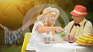 The Old Couple Is Drinking Cold Lemonade In The Summer Garden