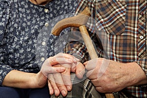 Old couple hands with cane