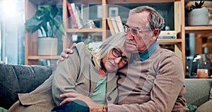 Old couple, hug and grief comfort on sofa in home for mental health sadness, loss or compassion. Men, woman and embrace