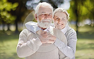 Old couple hug in park with love and smile in portrait, retirement together with trust and support with care. Elderly